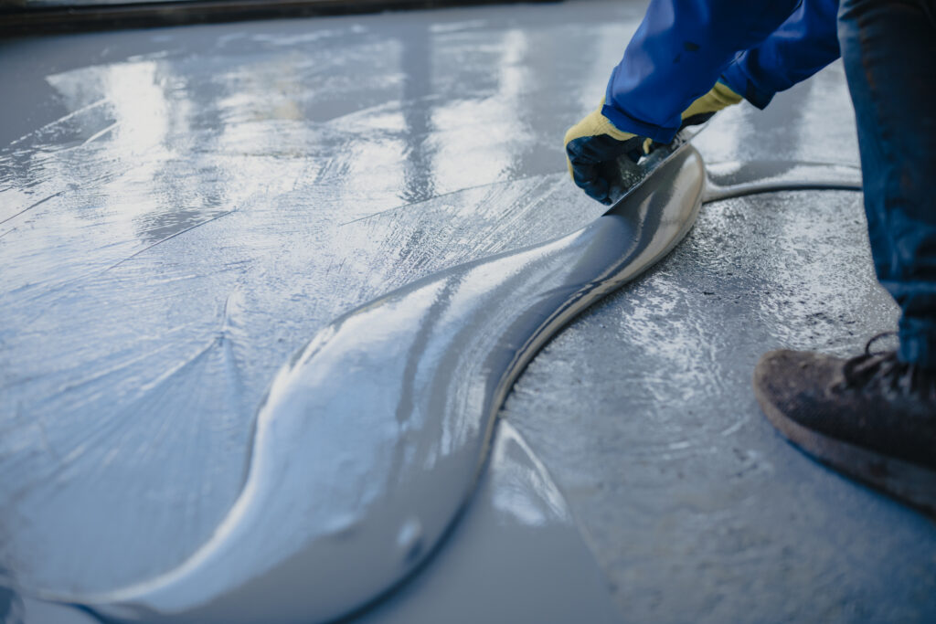 Epoxy floors vs polished concrete comparison in a Kansas City garage showing durable flake epoxy coating finish.
